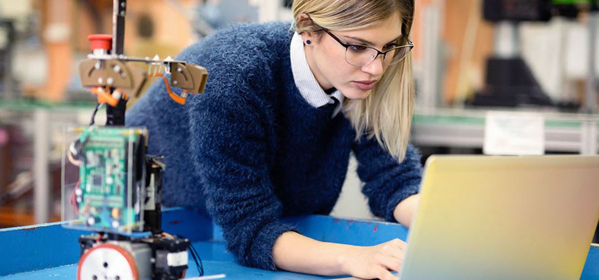 Photo of a woman working on a laptop